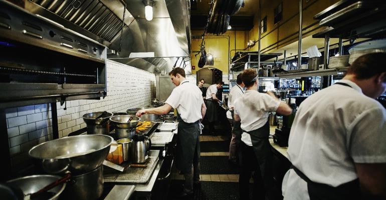 Chef and kitchen staff preparing dinner in kitchen.jpg