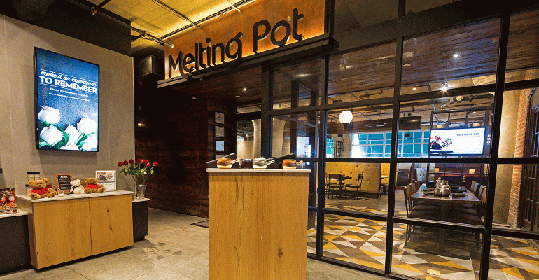Melting Pot’s new design features ‘hot kitchen,’ expanded bar