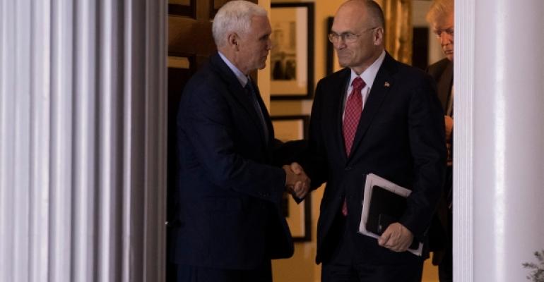 Andy Puzder CEO of CKE Restaurants shakes hands with vice presidentelect Mike Pence after a meeting in November Photo Drew AngererGetty Images