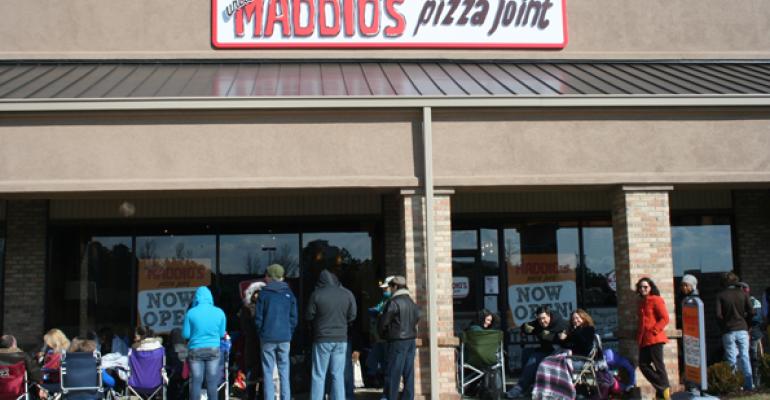 Customers line up at an opening day event at an Uncle Maddios restaurant