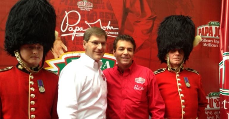 Papa Johns president and COO Tony Thompson second from left celebrates the chains 1000th international unit with founder and CEO John Schnatter