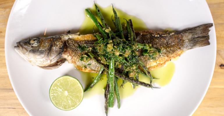 Whole Branzino topped with charred green beans is on the menu at Jeffreyrsquos Grocery in New York City