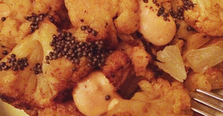 Chef Andrew Zimmerman serves an Indianinspired cauliflower side dish at Sepia in Chicago