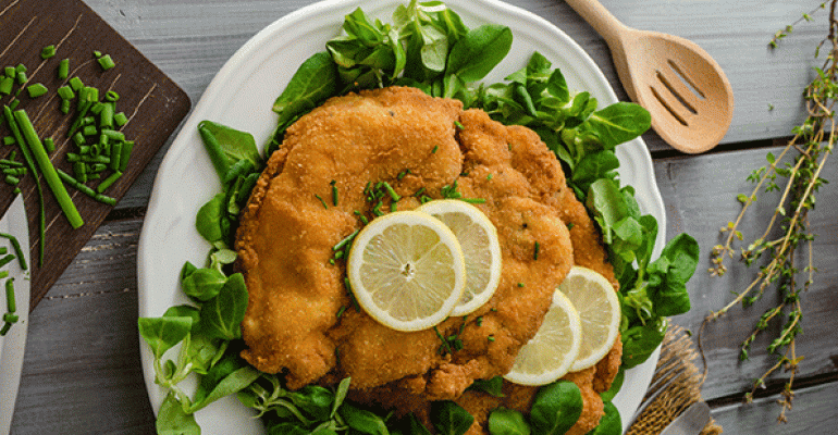 Schnitzel German for cutlet is the slice of meat thatrsquos typically dipped in egg before being dredged in breadcrumbs and panfried