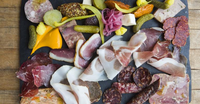 The salumi board at Cure in Pittsburgh features a selection of housefermented salumi and vegetables mustard and more