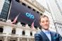 Noah Glass in front of the New York Stock Exchange displaying the Olo logo