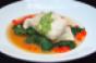 Shallow poached American red snapper with crab cake ravioli and green rouille